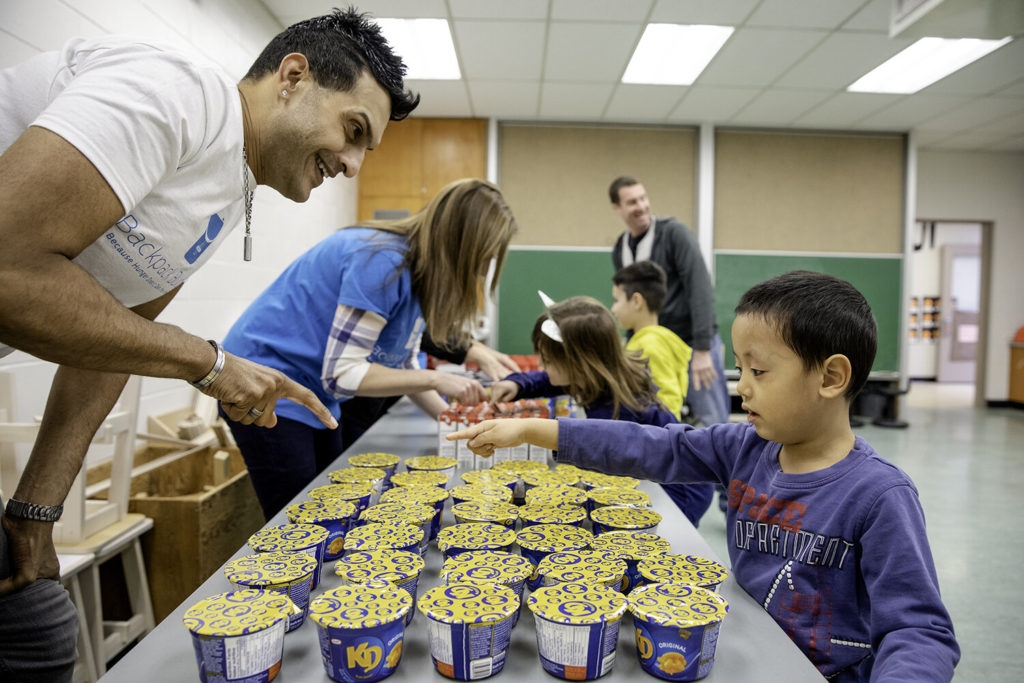 Backpack Buddies staff helping children choose food